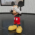 Mickey Mouse Doll With Big Black Ears Red Pants White Gloves And Yellow Shoes In Indoor Setting
