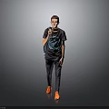 Man Wearing Gray T-shirt Blue Graphic Dark Pants Orange Shoes With Backpack Against Gray Background
