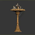 Elegant Golden Pedestal Table With Decorative Candles On Top And Intricate Carved Decorations