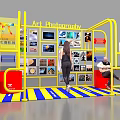 Art Photography Exhibition Booth With Yellow Frame Blue Yellow Striped Mat Displayed Photos And People