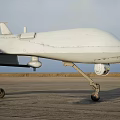 White Unmanned Fighter Drone Flying High In Sky With Long Wings And Payload