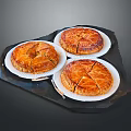 Three Delicious Baked Puff Pastry Tarts Displayed On White Plates Over Dark Tray