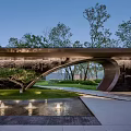 Modern Architectural Entrance Gate With Curved Structure Lush Lawn Trees And Water Feature