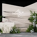 Luxe Check in Photo Spot With Beige Pleated Backdrop Green Plants And White Flowers