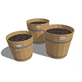 Three Decorative Wooden Planter Buckets With Metal Bands And Soil Inside