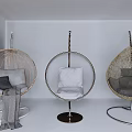 Modern Hanging Rattan Chairs With Metal Frames And Gray White Cushions In White Room