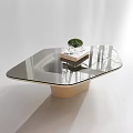 Modern Coffee Table With Glass Top Wooden Base And Small Potted Plant On Books