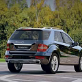 Mercedes Benz SUV Parked On Outdoor Parking Lot With Trees
