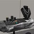 Elegant Black Rock Display Shelf Showcasing Layered Necklace And Small Jewelry Boxes