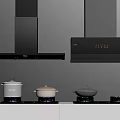 Modern Kitchen Appliances Featuring Black Range Hoods Gas Stoves And Cookware On Countertop