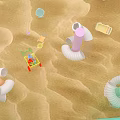 Cute Doll in Red Cart on Sandy Beach with Colorful Inflatable Rings and Beach Toys