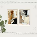 Framed Abstract Paintings on Decorative White Wall with Green Plant and Table Lamp