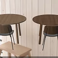 Round Wooden Table And Chair Sets With Gray Cushions And Black Metal Legs