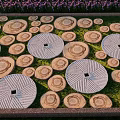 Circular Stepping Stones Path in Garden With Green Grass and Purple Flowers