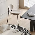 Modern Light Seat Dining Chair With Black Metal Legs Near Table Books On Wood Floor