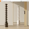 Brown and White Stacked Sphere Sculptures with Cylindrical Bases in Soft Light Interior