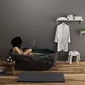 Dark Stone Freestanding Bathtub With Bathrobe On Rack Plants Stool And Wooden Floor Rug