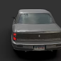 Vintage Dark Gray Sedan With Illuminated Headlights And Silver Rims