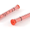 Two Pink Syringes With Graduated Scale Transparent Barrels And Red Caps