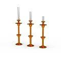 Three Orange Decorative Candle Holders With White Candles On White Background
