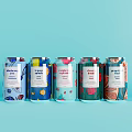 Colorful Sparkling Drink Cans With Different Flavors And Vibrant Patterns On Light Blue Background