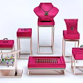 Elegant Jewelry Display Featuring Necklaces Rings Earrings On Pink Boxes And Stands