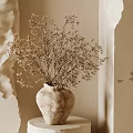 Dried Flowers In Terracotta Vase On Round Pedestal With Neutral Wall And Soft Light