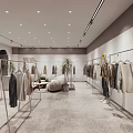 Modern Clothing Store Interior With Hanging Clothes Sofa Seating And Potted Plants