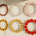 Decorative Ornament Set with Various Colored Circular Wreaths and Multiple Styles on Wooden Background