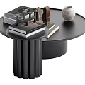 Modern Round Black Coffee Table with Stacked Books Decorative Sculpture and Ceramic Vase