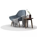 Comfortable Blue Lounge Chair With Checkered Blanket And Side Table With Green Plant