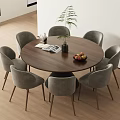 Modern Round Wooden Dining Table With Six Grey Chairs And Green Plant On Wooden Floor