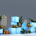 Decorative Arrangement Of Blue Letter Cubes With Orange Yellow Flowers Green Plants And Glass Birdcage 3d model