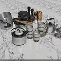 Stainless Steel Dinnerware Set With Assorted Cooking Utensils Teapot And Cups On Marble Countertop