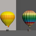 Yellow Orange Striped and Multicolored Hot Air Balloons Displayed on Gray Tabletop