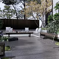 Modern Courtyard Garden with Outdoor Sofa Coffee Table Lush Plants Trees and Gray Stone Slabs