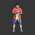 A man holding a cat in orange T-shirt and blue shorts against black background