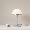 Table Lamp Featuring White Dome Shade Silver Base And White Cup On Light Colored Tabletop 3d model