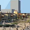 Bustling Commercial Street With Colorful Shop Buildings Pedestrian Area Central Fountain And Trees