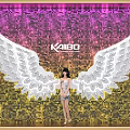 Popular Photo Spot With Giant White Wings And Sequin Background Featuring KAI80 Logo