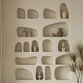 Beige Wall Featuring Irregular Shaped Built In Wall Cabinets With Decorative Items And Potted Plant