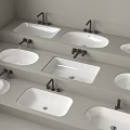 Multiple White Bathroom Washbasins With Black Faucets On Grey Countertops Various Shapes