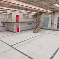 Industrial Parking Garage Interior With Brick Walls Concrete Floor Red Door And Staircase