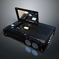Vintage Black Portable Computer Device Featuring Open Screen Control Buttons And Speaker Grille