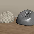 Two Beige Checkered and Gray Bean Bag Chairs on Wooden Floor with Light Wall