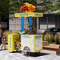 Sweet Heart Souffle Mobile Street Food Cart With Bicycle And Pedestrians Near Modern Building