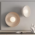 Scalloped Design Cream Wall Lamps Mounted on Light Wall with Decorative Sculpture and Books