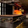 Modern Bar Interior Design With Sleek Counter Black Stools And Warm Ambient Lighting