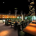 Elegant Restaurant Interior With Wooden Wall Decor Frames Dining Table Green Chairs And Pendant Lights