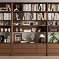 Wooden Bookcase With Books Decorative Sculptures Framed Photos And Potted Plant